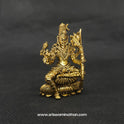 Three-quarter front right perspective view of the two and a half inch brass seated Lalitha Tripura Sundari statue showcasing the detailed crown and her sacred weapons.