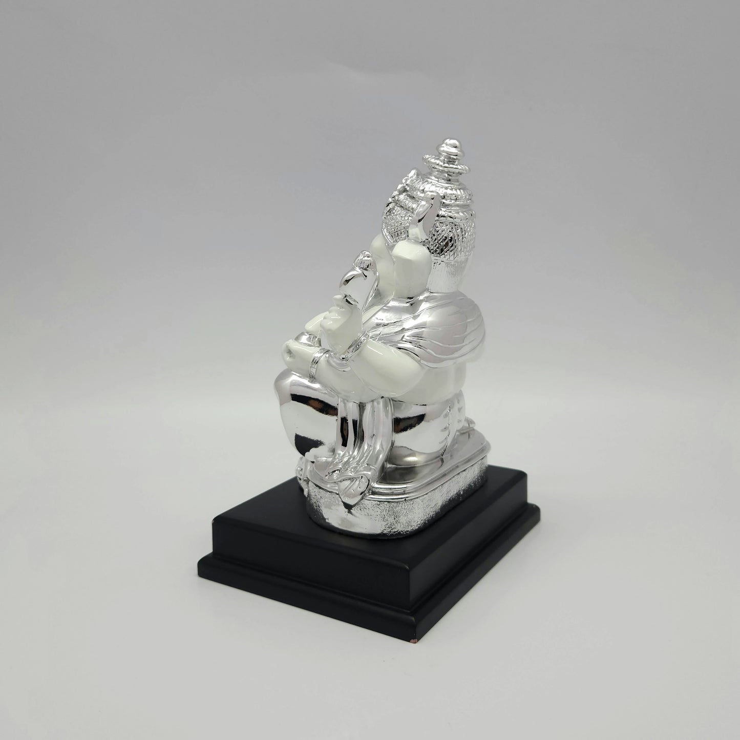 Right side view of the 7.5 inch silver accents resin Ganesha figurine displaying the elegant depth of the seating posture.