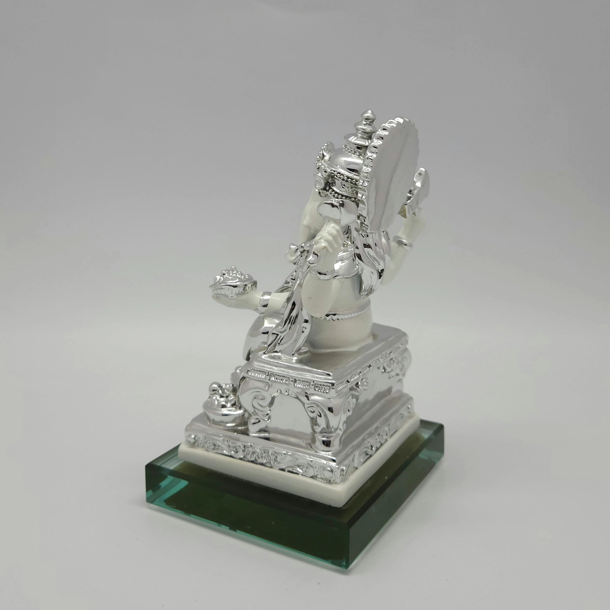 Right side view of the 6.9 inch silver paint resin Ganesha figurine displaying the elegant thickness of the ornate throne back halo.