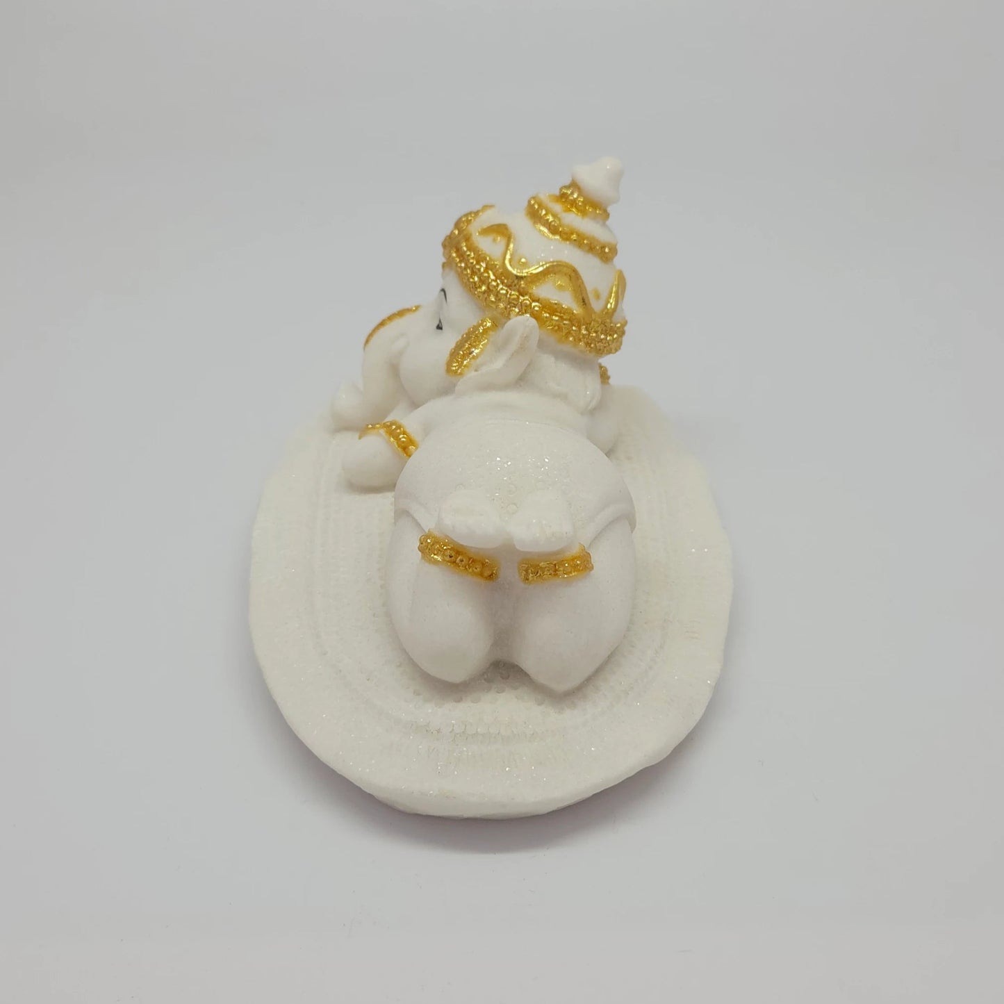 Full back view of the 2.8 inch reclining marble-like Ganesha idol demonstrating its perfect proportions for car dashboard placement.