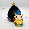 Angled view showing the 11cm white resin Ganesha idol sliding forward and out of the deep metallic purple back archway shell