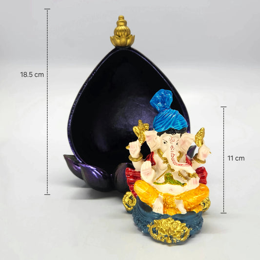 Angled view showing the 11cm white resin Ganesha idol sliding forward and out of the deep metallic purple back archway shell