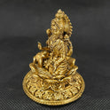 Three-quarter front left perspective view of the solid brass Aishwarya Lakshmi statue highlighting the wealth pot and the deep three-dimensional thickness of the casting