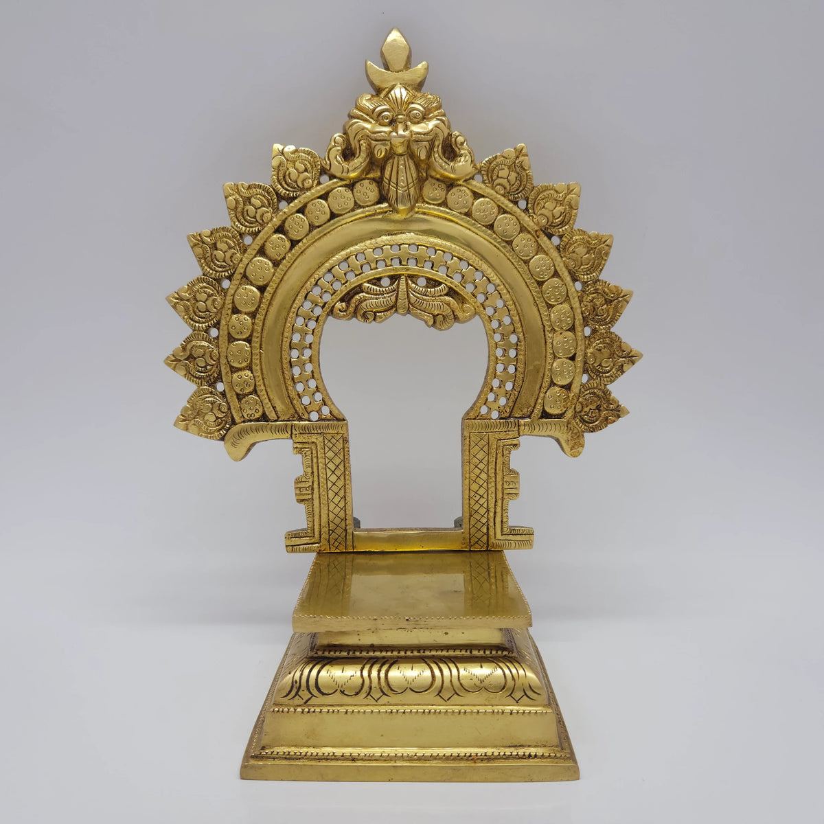 Direct straight front view of the premium solid brass Prabhavali Singhasan throne showcasing the detailed Kirtimukha apex and empty flat deity platform by Sri Swaminathan and Co.
