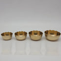Direct straight front view of the premium solid brass bloom lotus katori bowl set showcasing the mini small big and large size variants arranged in a horizontal row by Sri Swaminathan and Co.