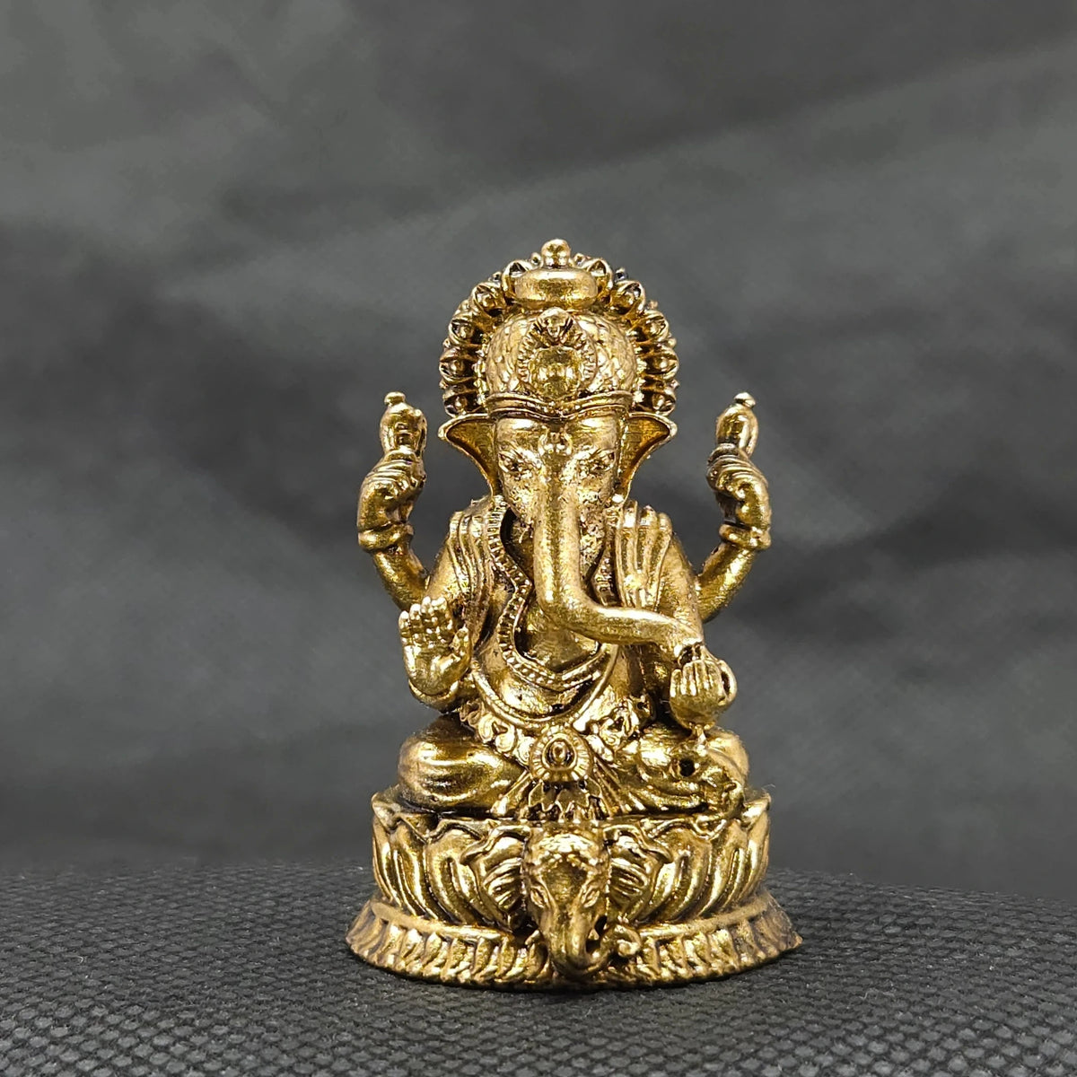 Straight front view of the premium solid brass Ganesha statue showing the Lord seated on a round lotus base featuring a central elephant head by Sri Swaminathan and Co