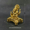 Three-quarter front right perspective view of the brass Ganesha statue showcasing his prominent fat abdomen, the detailed laddu sweet, and the ornate elephant heads on the base corners.