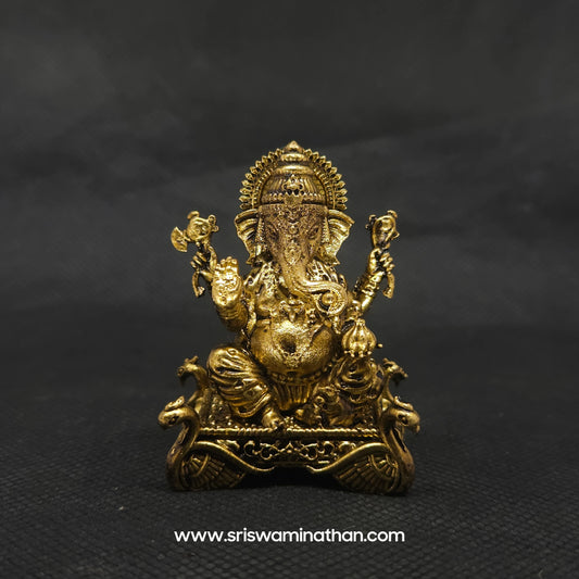 Straight front view of the premium solid brass Ganesha statue showing the deity with a prominent dhondhi fat abdomen holding a modak on a four-sided hamsa throne.