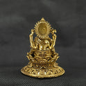 Direct straight back view of the solid brass Ganesha statue on a round lotus pedestal demonstrating the detailed rear surface of the sunburst halo crown and smooth reverse base contours.