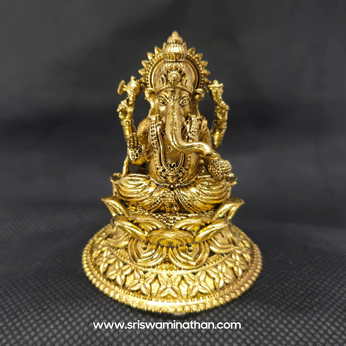 Straight front view of the premium solid brass Ganesha statue showing the Lord seated in Padmasana on an intricately carved round lotus peedam base by Sri Swaminathan and Co.
