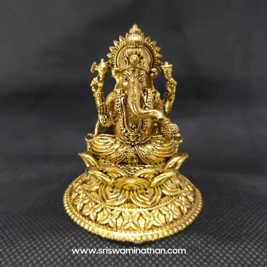 Straight front view of the premium solid brass Ganesha statue showing the Lord seated in Padmasana on an intricately carved round lotus peedam base by Sri Swaminathan and Co.
