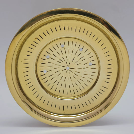  Direct overhead top down front view of the premium brass kanji vadicattu plate showing the central strainer holes and radiating chiseled line patterns by Sri Swaminathan and Co.
