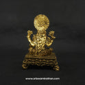 Direct straight back view of the solid brass Lakshmi statue demonstrating the detailed rear surface of the sunburst halo crown and back hair arrangement over the rectangular throne.