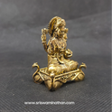 Three-quarter front right perspective view of the solid brass Lakshmi statue on a hamsa peedam highlighting her silky saree and the Akshaya Patra in her hand.
