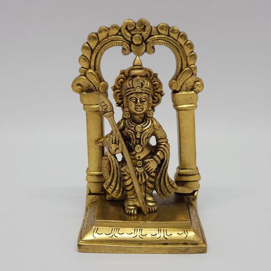 Direct straight front profile view of the premium solid brass Lord Murugan statue holding his sacred Vel inside an integrated circular Prabhavali archway by Sri Swaminathan and Co