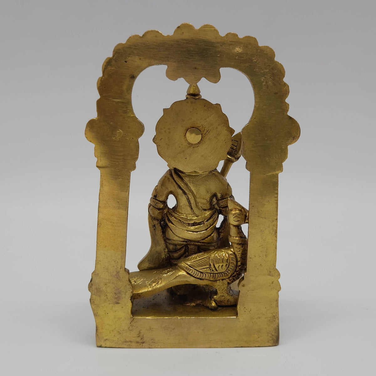 Sharp side profile view of the premium solid brass Murugan statue inside its permanent temple arch demonstrating the five point five centimeter depth clearance and flat reverse lines
