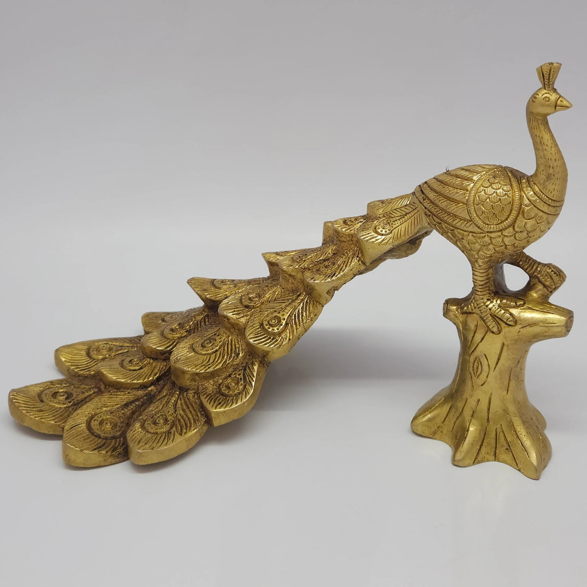Left profile standing view of the premium solid brass single peacock decor statue in antique layered finish by Sri Swaminathan and Co