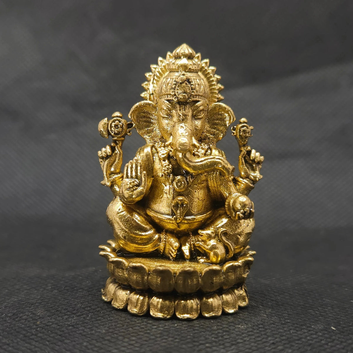 Straight front view of the premium brass Ganesha statue showing the Lord and Mooshikan seated together on a double-bloomed round lotus peedam base by Sri Swaminathan and Co