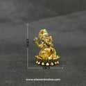 Three-quarter front left perspective view of the one inch brass Ganesha statue highlighting the chiseled lines of his traditional weapon armors and the deep three-dimensional thickness of the casting.