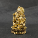 Three-quarter front right perspective view of the brass Ganesha statue showcasing his prominent fat abdomen, the detailed modak, and Mooshikan seated on the round lotus edge.