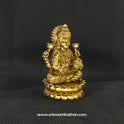 Three-quarter front left perspective view of the solid brass seated Lakshmi statue with Akshaya Patram highlighting her lengthy hair curls and the deep three-dimensional thickness of the casting