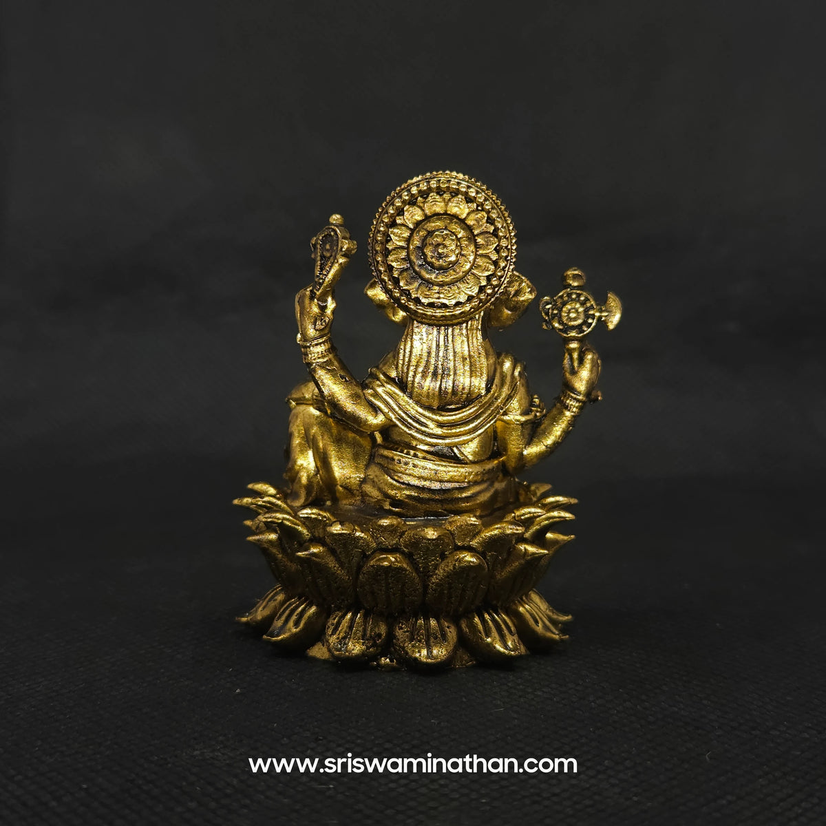 Direct straight back view of the solid brass seated Lalita Ganapati statue demonstrating the detailed rear surface of the sunburst halo crown and smooth back contours of the lotus seat