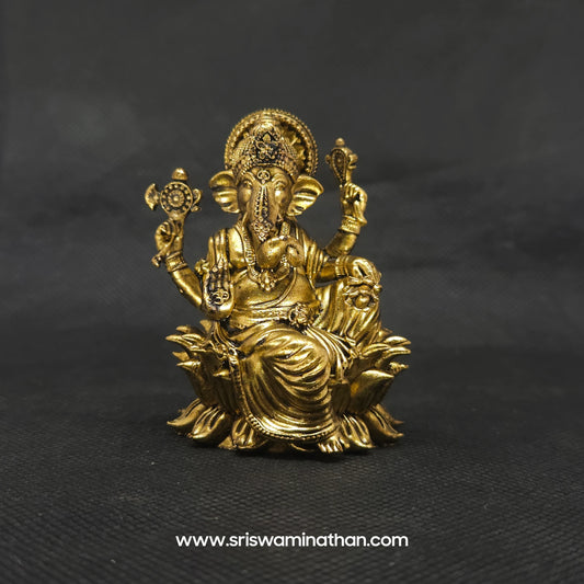 Straight front view of the premium solid brass seated Lalita Ganapati statue showing the Lord in complete royal ease on a bloomed lotus petal pedestal by Sri Swaminathan and Co
