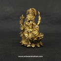 Three-quarter front left perspective view of the solid brass seated Lalita Ganapati statue highlighting the sharp detailed lines of the attributes and the deep three-dimensional thickness of the casting.
