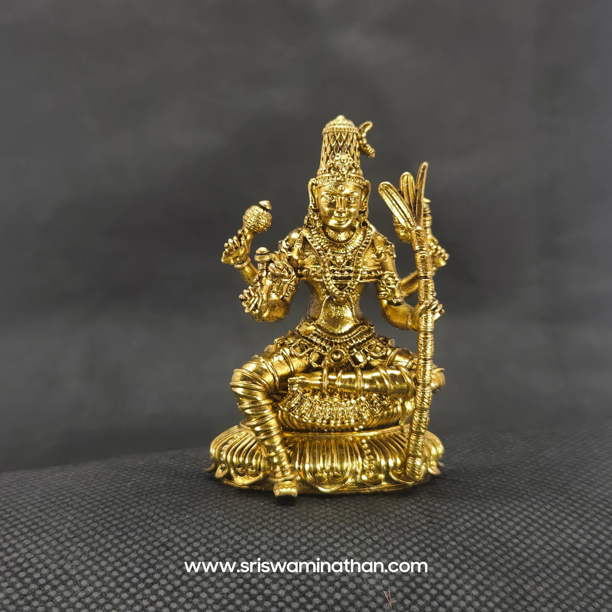 Straight front view of the premium solid brass seated Lalitha Tripura Sundari statue showing the goddess holding her sugarcane bow on a round lotus peedam by Sri Swaminathan and Co