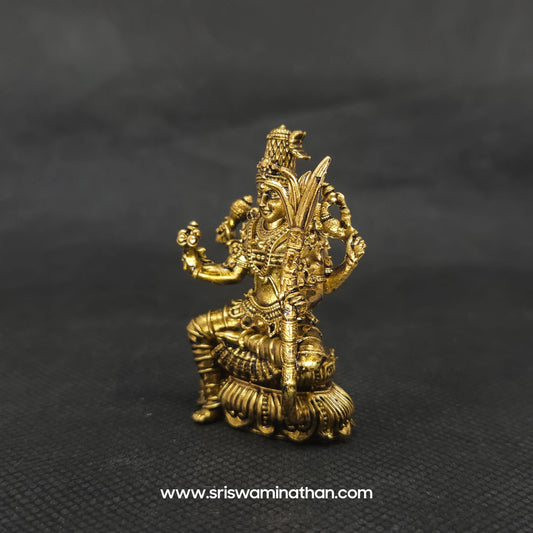 Three-quarter front left perspective view of the solid brass seated Lalitha Tripura Sundari statue highlighting her lengthy hair curls and the deep three-dimensional thickness of the casting