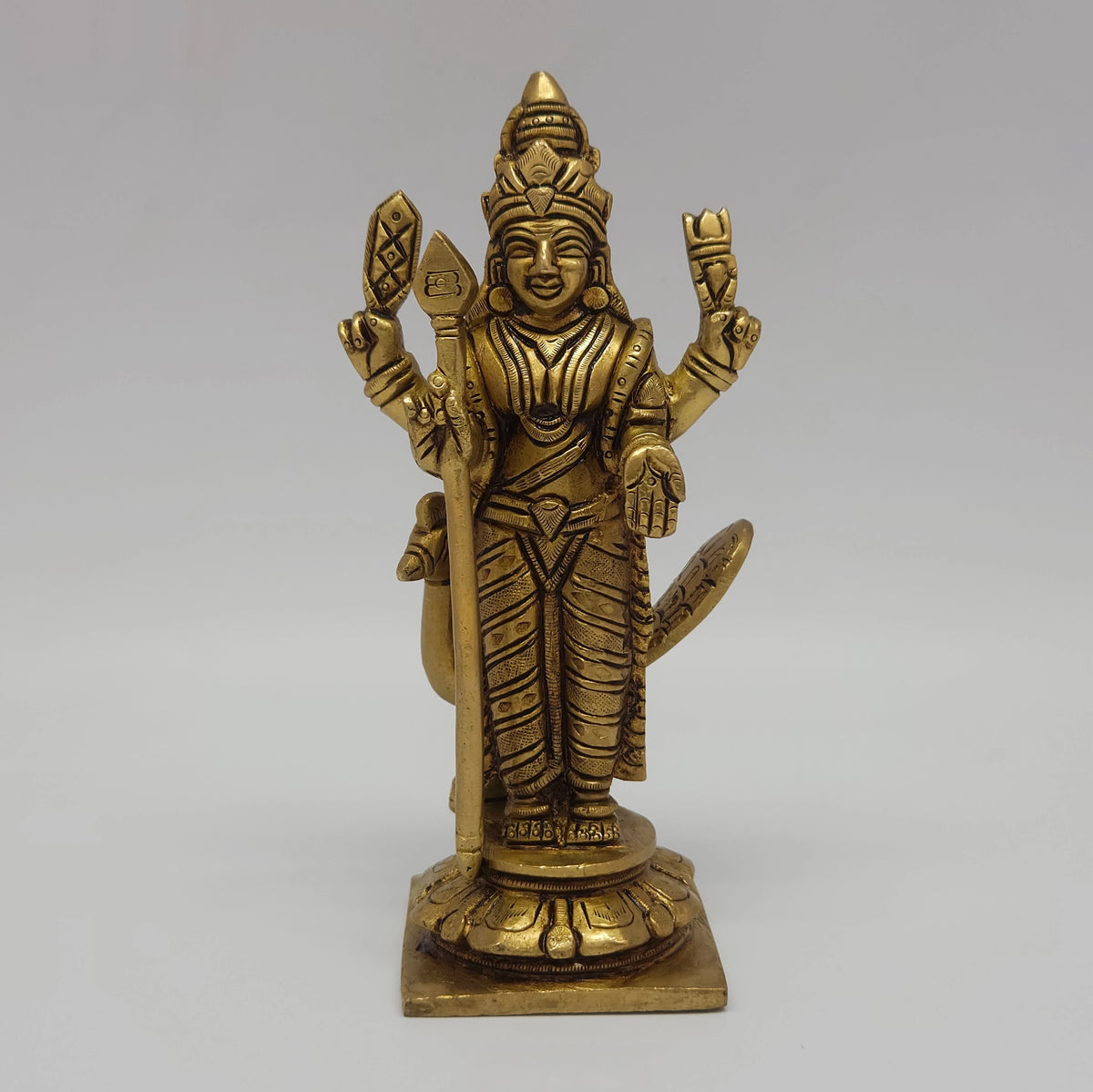 Direct straight front view of the premium solid brass standing Skanda statue showing the open peacock design behind his left side by Sri Swaminathan and Co.