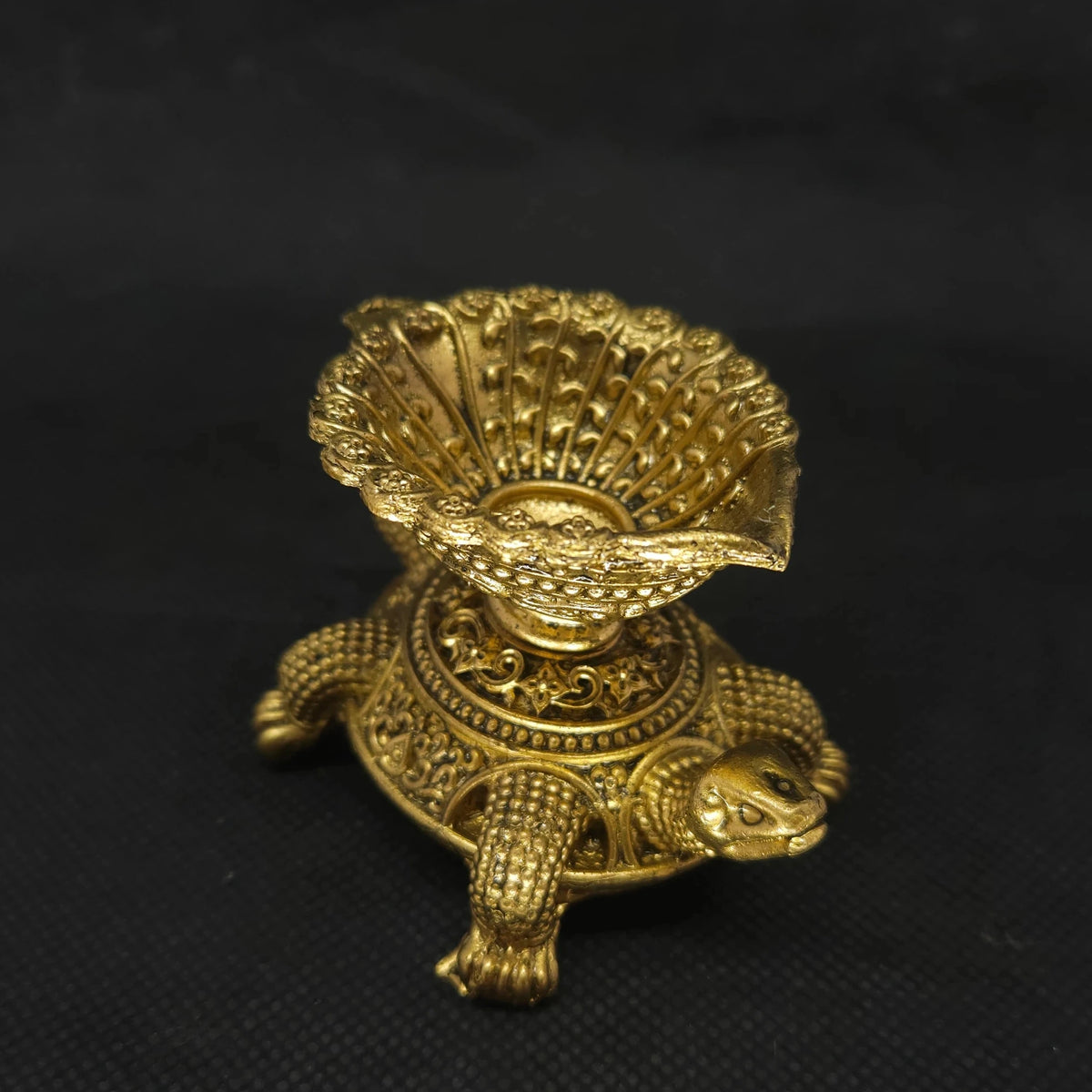 Three-quarter front Ariel perspective view of the solid brass Tortoise oil lamp highlighting the detailed texture of the shell and casting thickness.