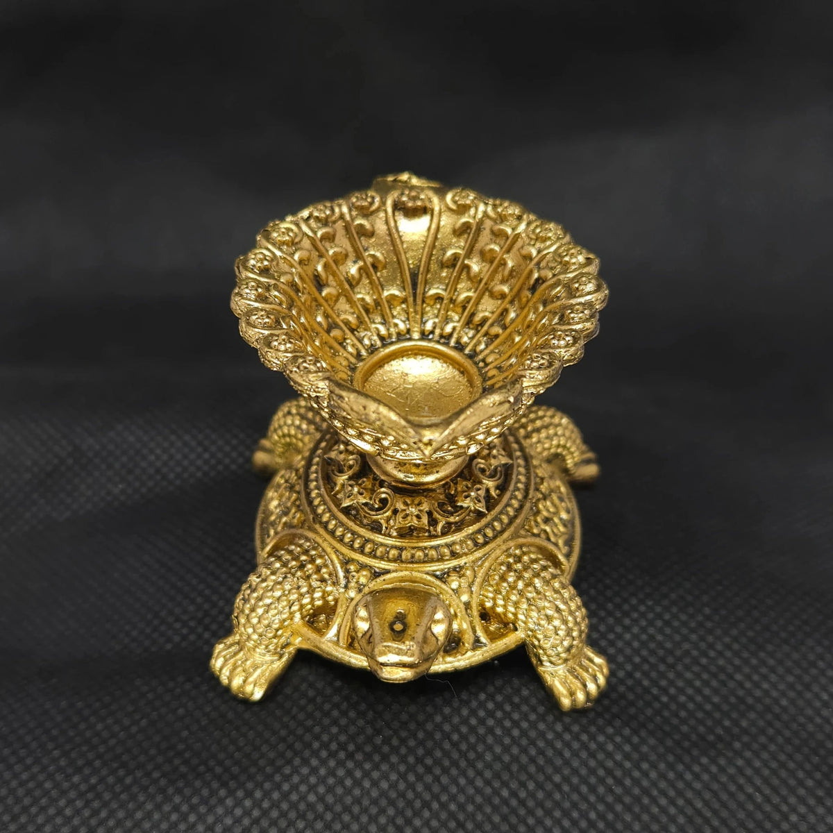 Straight front view of the premium solid brass Tortoise vilakku deepam lamp showing the ornate oil bowl supported on the tortoise shell by Sri Swaminathan and Co.