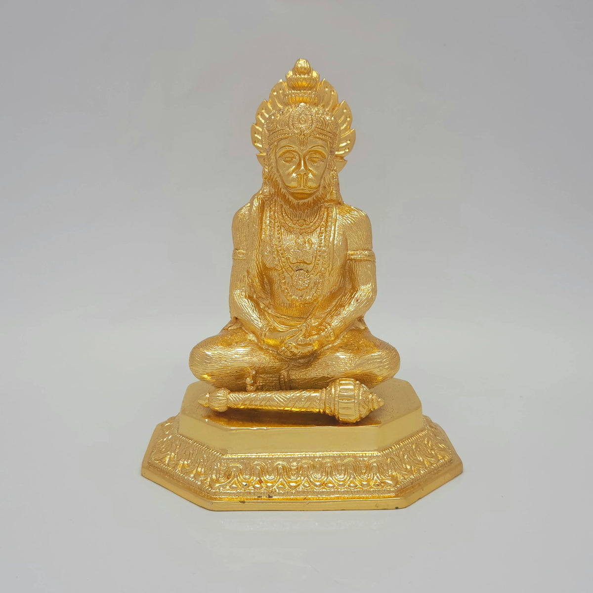 Alternative front profile view of the premium gold coated meditating Lord Hanuman statue highlighting the natural bright white light glints reflecting off the glossy golden mirror finish.