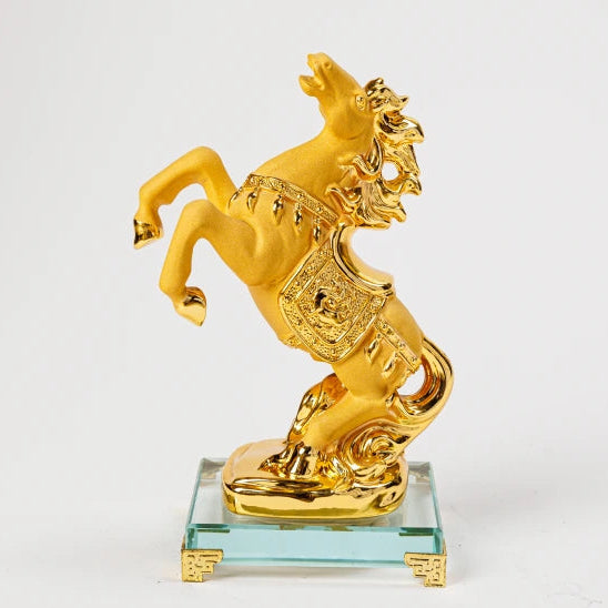17.5cm premium luxury gold paint finish resin Feng Shui rearing victory horse statue with a polished ceremonial saddle on a clear crystal base by Sri Swaminathan and Co.
