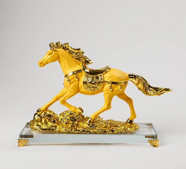 23.5cm premium luxury gold paint finish resin Feng Shui running tribute horse statue on a wealth bed of coins over a clear crystal base by Sri Swaminathan and Co.