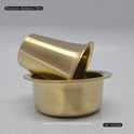 Three-quarter front view of the premium solid bronze Kumbakonam dabarah tumbler set showing the tumbler propped elegantly inside the dawara bowl by Sri Swaminathan and Co.
