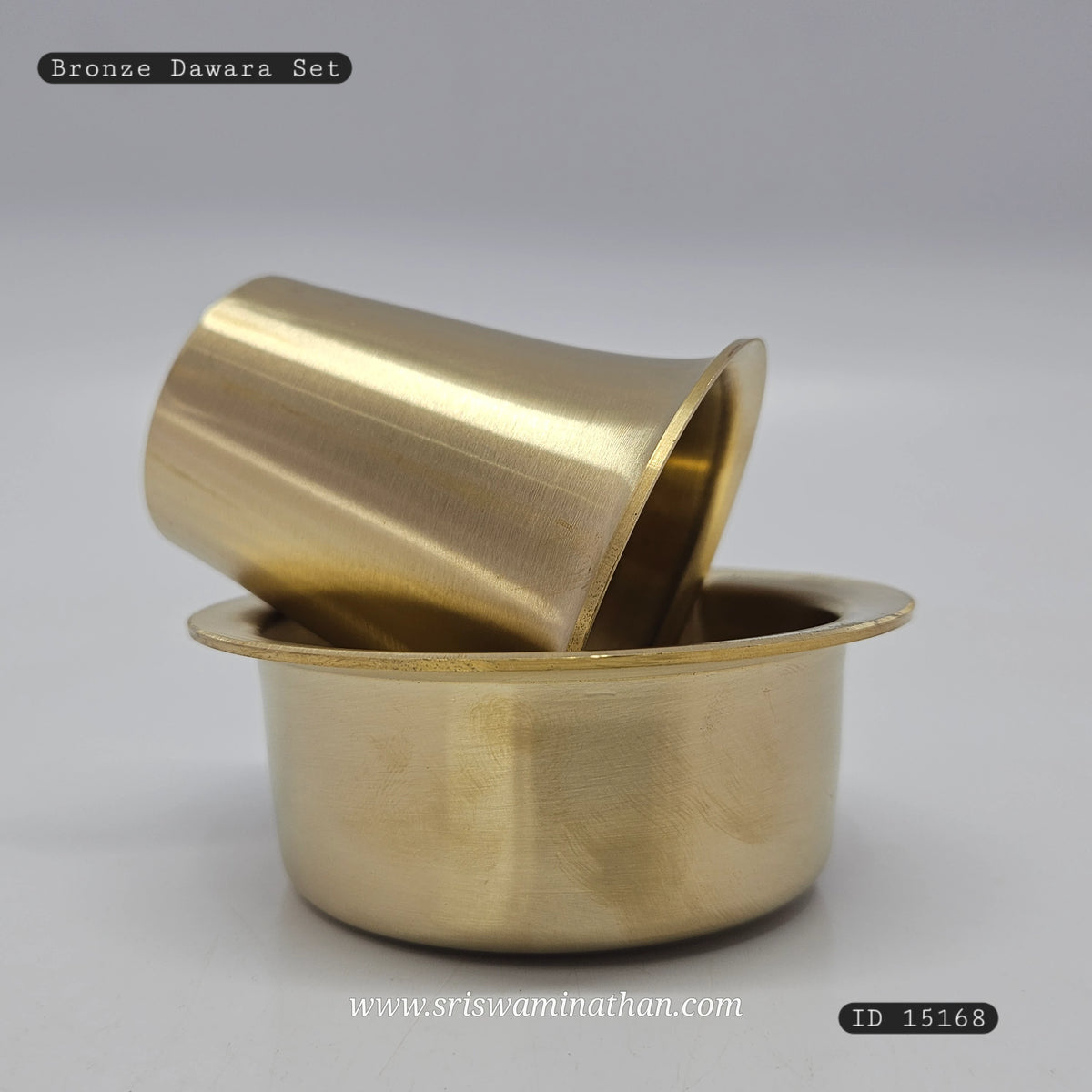 Three-quarter front view of the premium solid bronze Kumbakonam dabarah tumbler set showing the tumbler propped elegantly inside the dawara bowl by Sri Swaminathan and Co.
