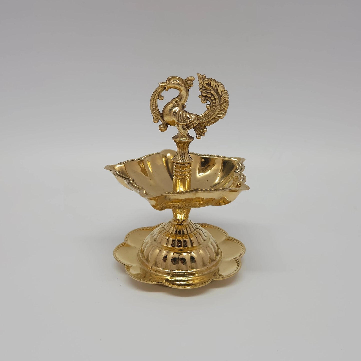  Fine quality pure brass peacock oil lamp with a flower-shaped base plate.