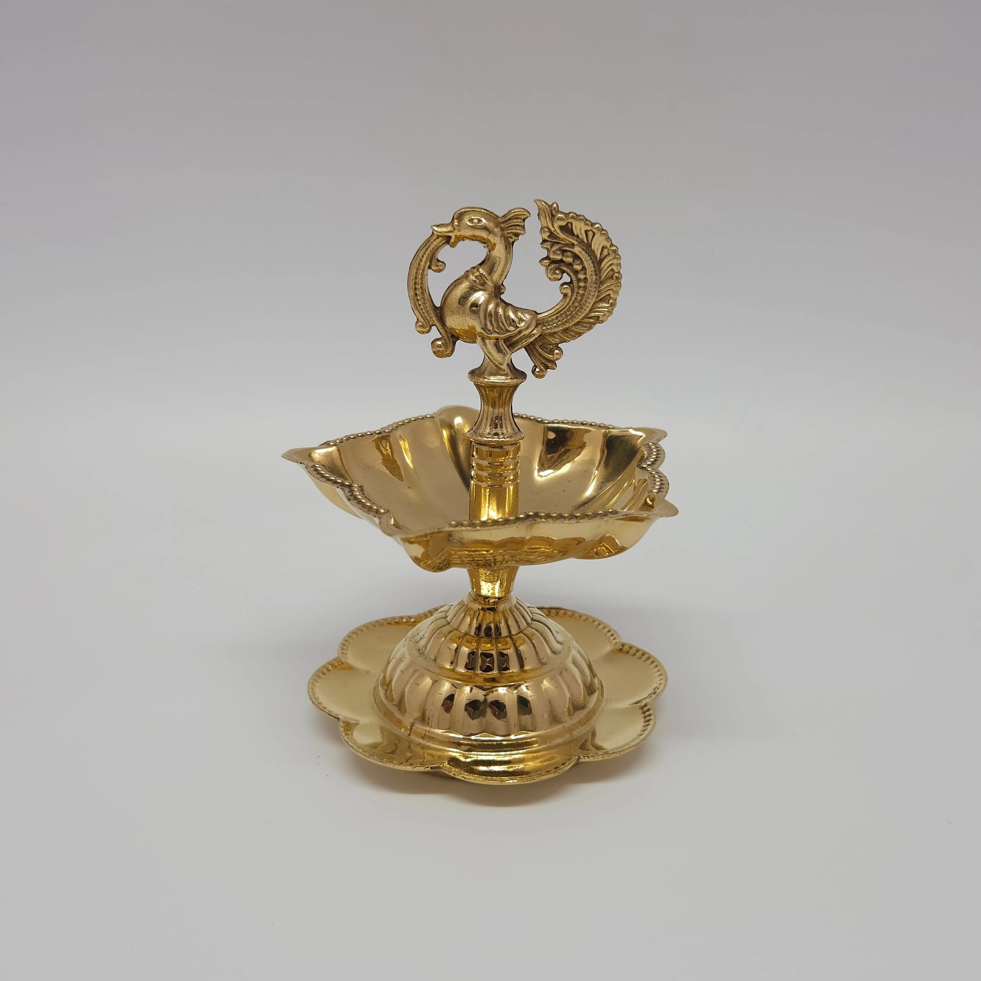  Fine quality pure brass peacock oil lamp with a flower-shaped base plate.