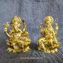 Front perspective view showcasing a paired set of the two point seven five inch brass seated Lalita Ganapati statue alongside a matching seated Lakshmi idol on an altar display