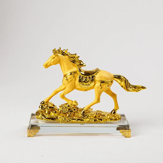 13cm premium royal gold dust finish resin Feng Shui galloping horse statue running over a wealth bed of coins on a clear crystal base by Sri Swaminathan and Co.