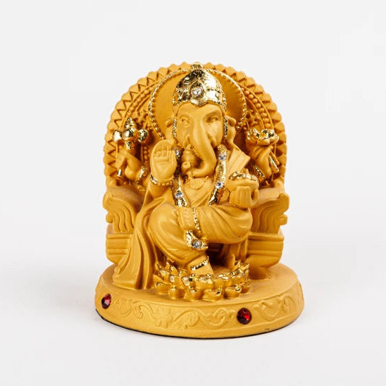 Small sandalwood-finish resin Ganesha idol with gold accents and crystal rhinestones seated on a throne by Sri Swaminathan and Co.