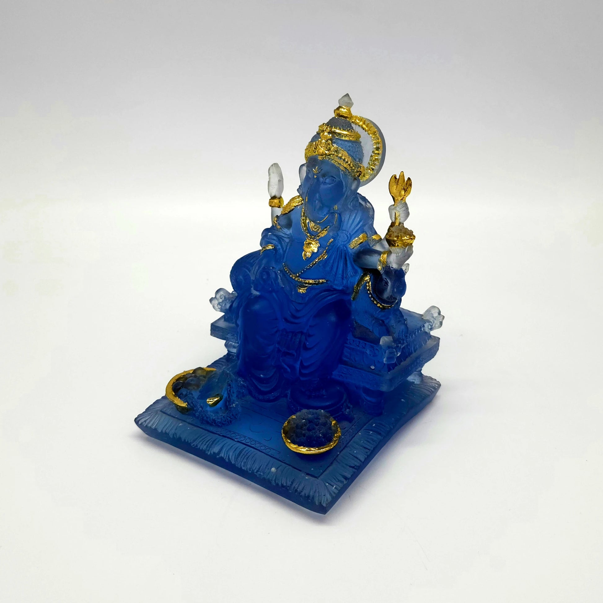Three-quarter left angle view from a lower perspective showing the depth of the textured blue throne base mats.