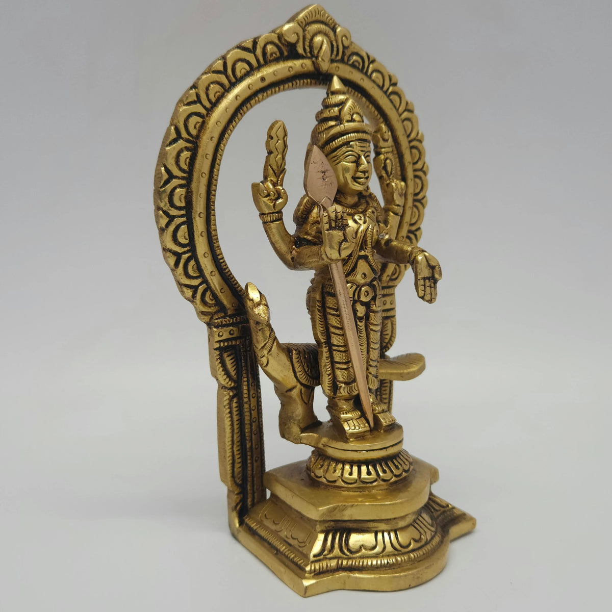• 
 Close up centered front view of the seventeen point five centimeter brass Tamil Kadavul Vadivelan statue showcasing his sacred Vel and traditional crown attributes.
