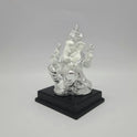 Left three-quarter angle view of the silver electroplated resin Ganpati idol showcasing the thick square dark pedestal stand.
