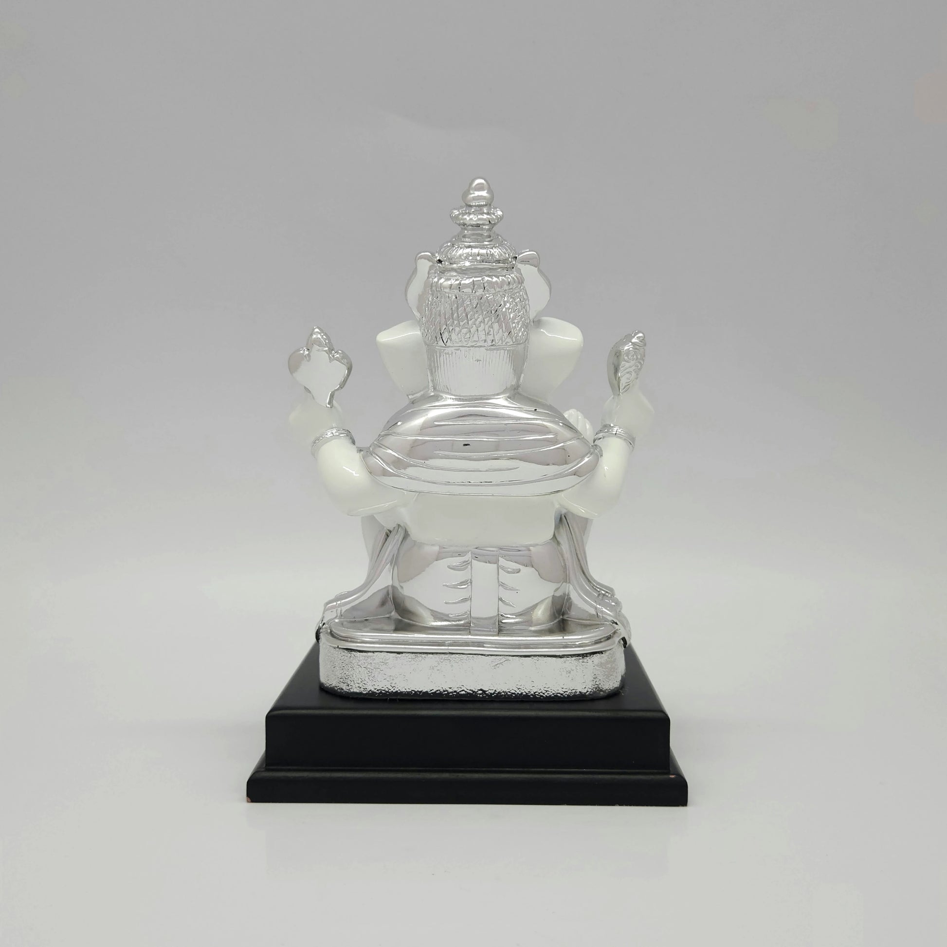 Full back view of the white marble texture resin Ganesha throne showing the clean lines mounted onto the premium black base platform.