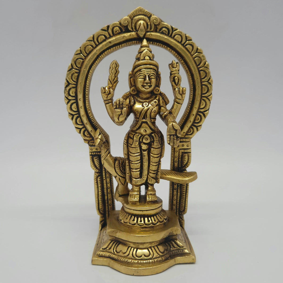 Three-quarter front left perspective view of the six point nine inch brass Kandhan statue demonstrating the thick side lines of the integrated archway casting