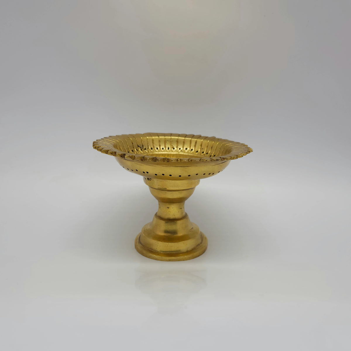 Straight side profile view of the 14cm solid brass pedestal ritual stand showing its 10cm height and sturdy base by Sri Swaminathan and Co.