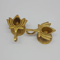 Display arrangement demonstrating two individual ten milliliter brass lotus handled lamps with one tilted forward to show the inner basin and wick placement groove.